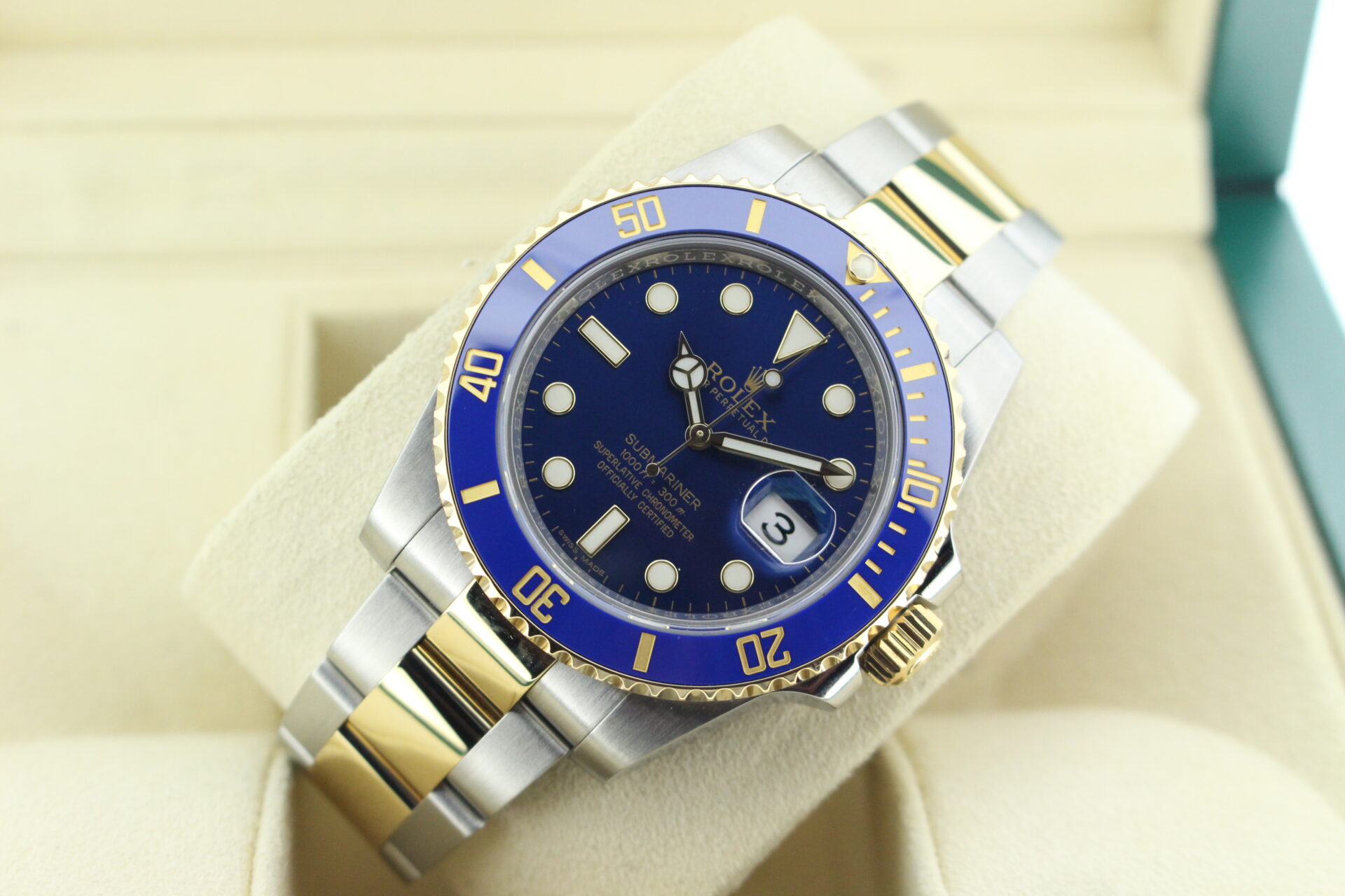 Rolex submariner blue kit at an angle with light reflecting on the dial