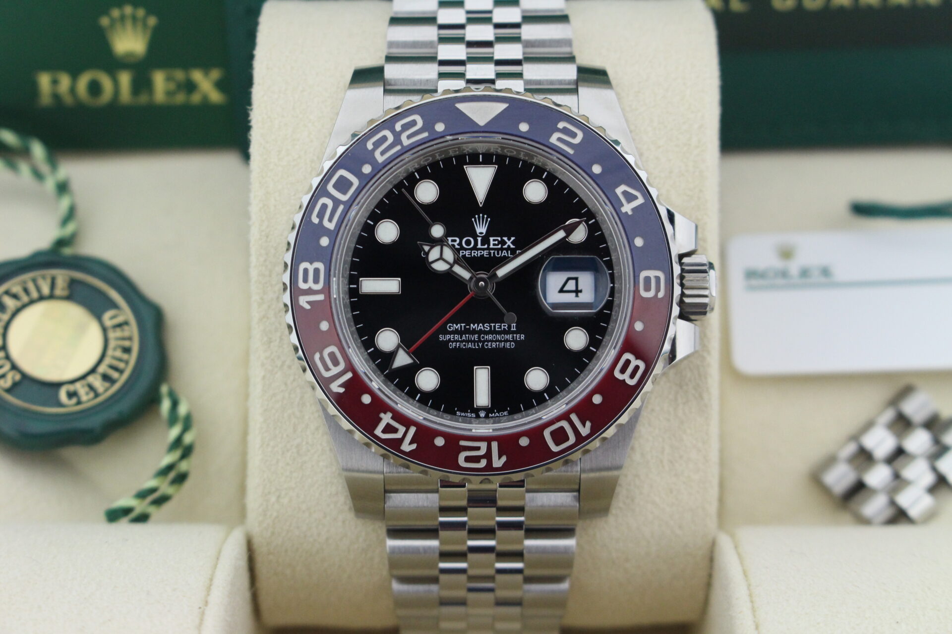 Close up of Rolex GMT Master II Pepsi 1261710BLRO in it's box with both swing tags, booklets and warranty card