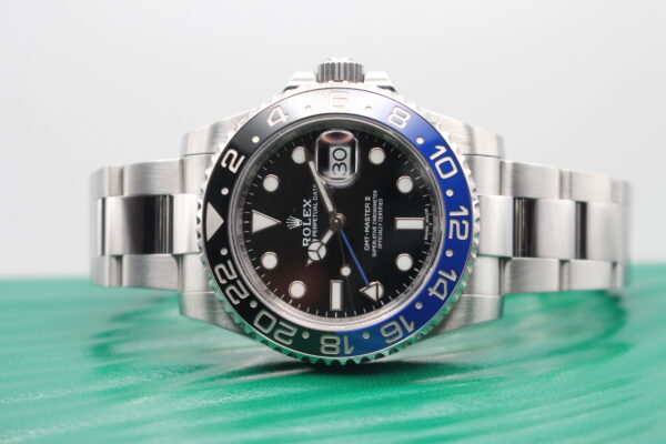 Rolex GMT Master II on top of its green wave box