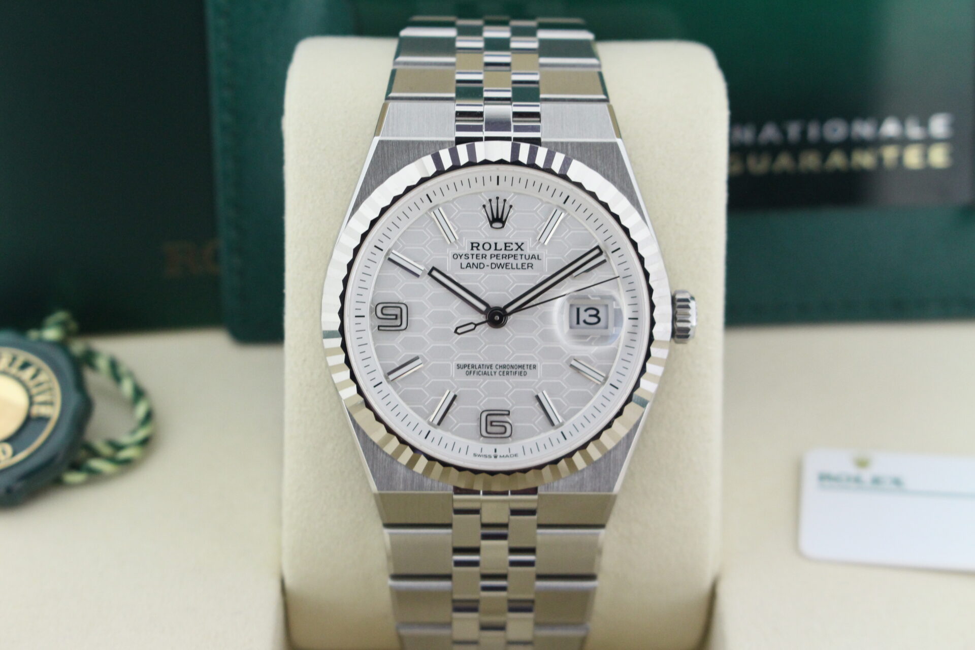 Close up of Rolex Land Dweller 40 127334 in it's box with both swing tags, booklets and warranty card