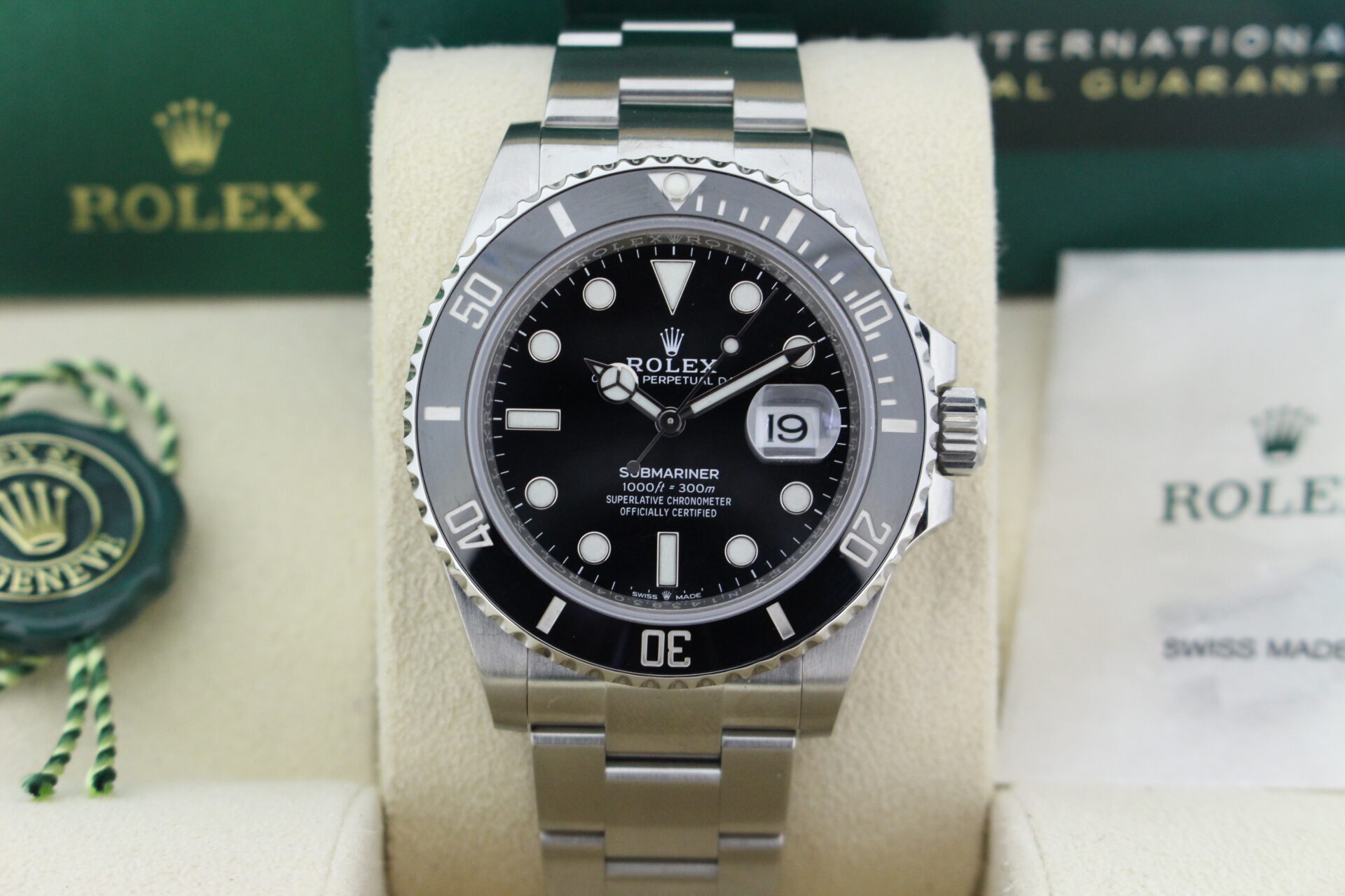 Close up of Rolex Submariner Date 41mm 126610LN in it's box with green swing tag, booklet and warranty card