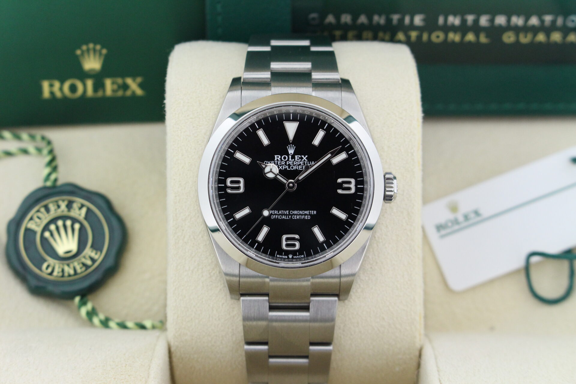Close up of Rolex Explorer I 36mm 124270 in it's box with both swing tags, booklets and warranty card