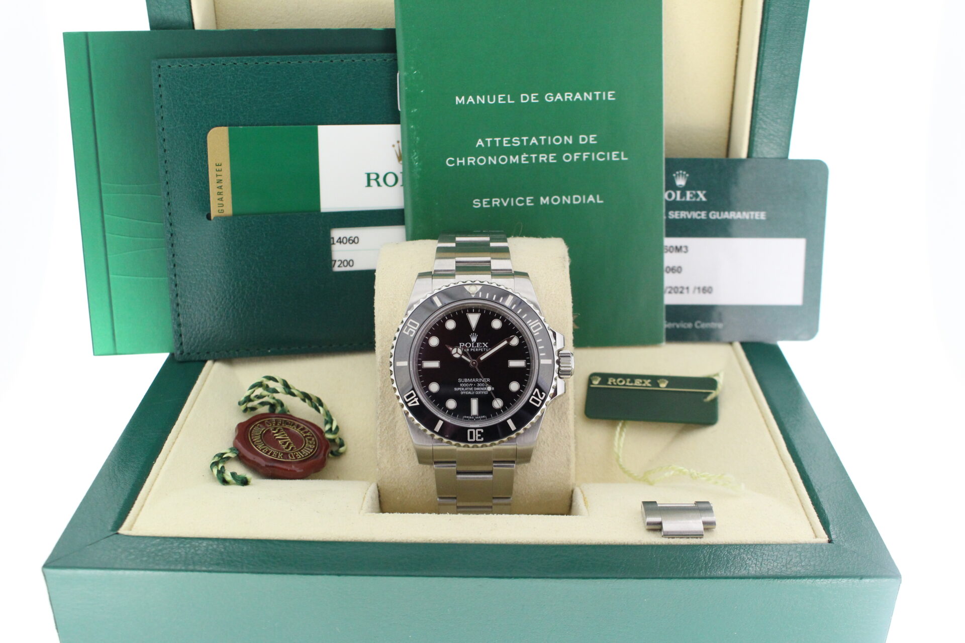 Rolex Submariner No Date 114060 in it's box with both swing tags, booklets and warranty card