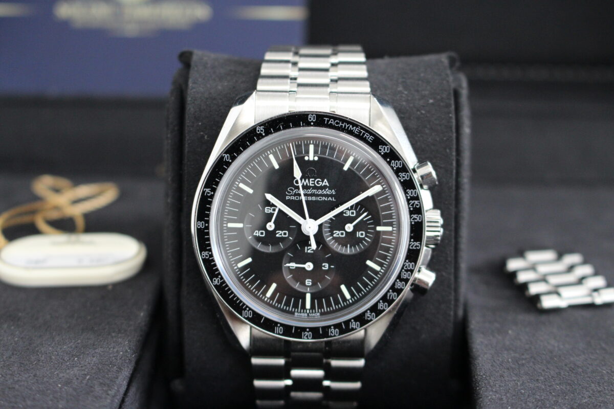 Omega Speedmaster on its cushion with swing tag and spare links on display