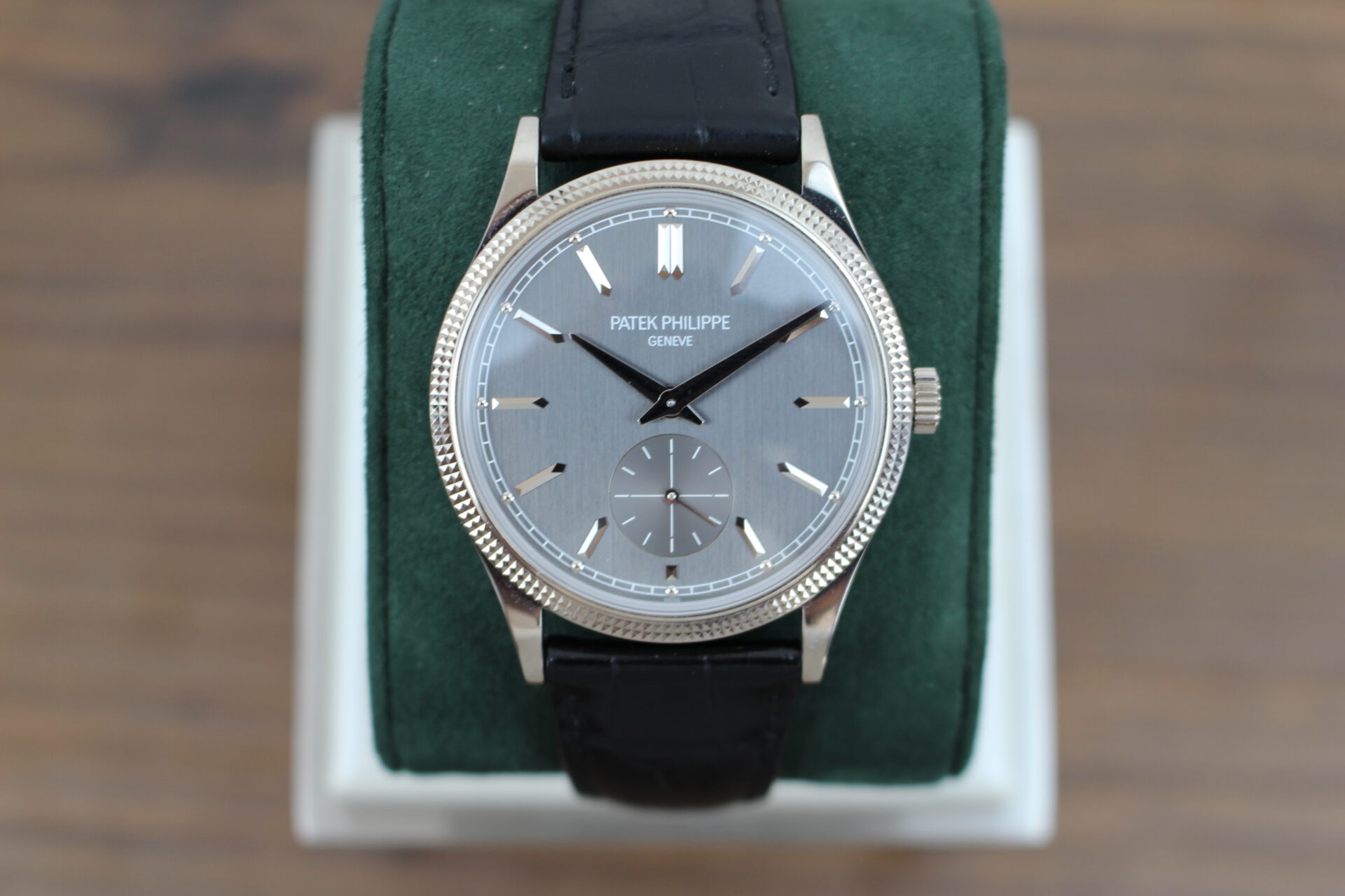 Patek Philippe Calatrava 6119G-001 on a green cushion
