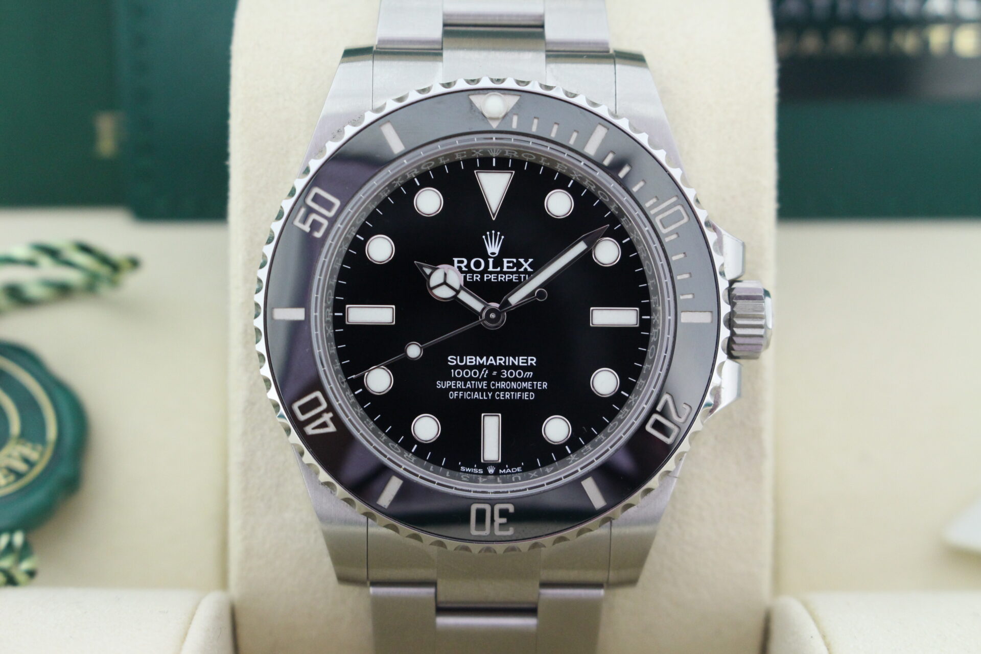 Close up of Rolex Submariner No Date 124060 in it's box with both swing tags, warranty card and booklets