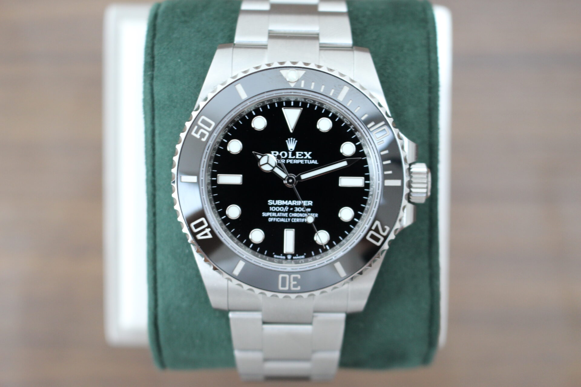 Rolex Submariner No Date 124060 on a green cushion
