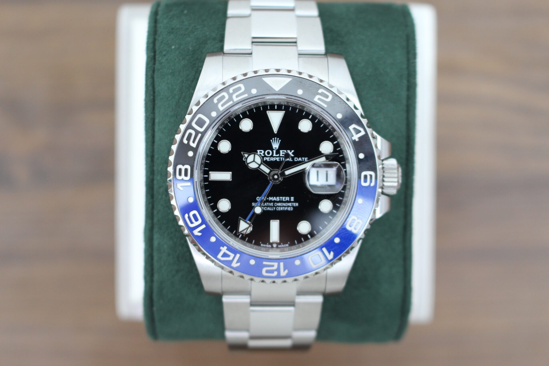 Rolex Batman on a green cushion
