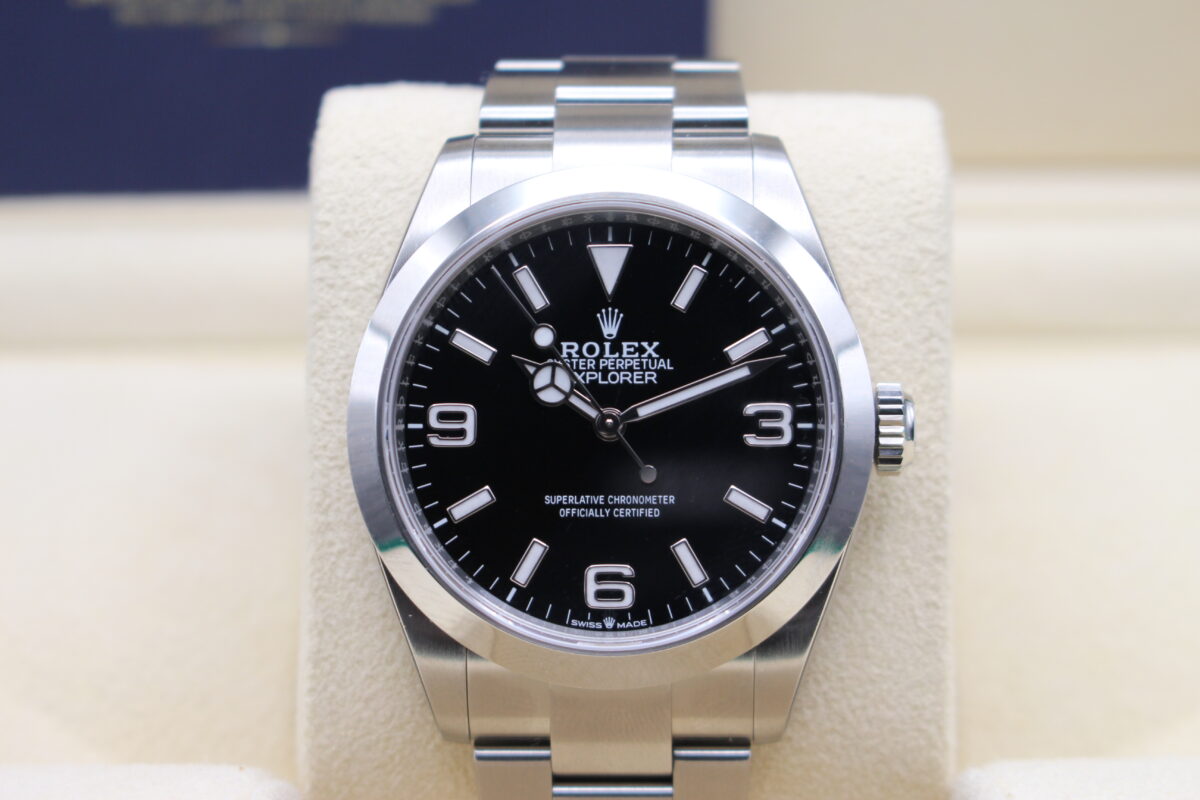 Rolex explorer I 40mm upright on its cushion reading 11 past 10