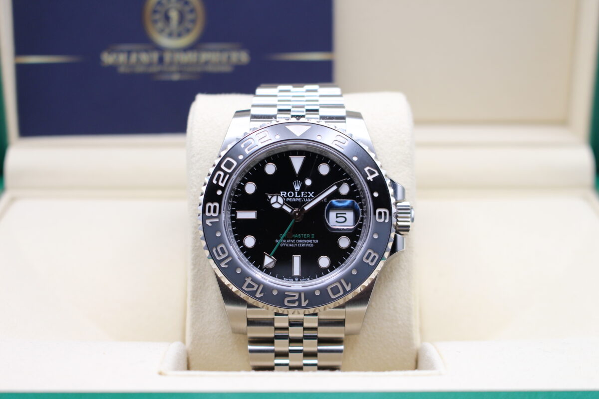 Rolex GMT Master II sat upright on its cushion inside a Rolex box