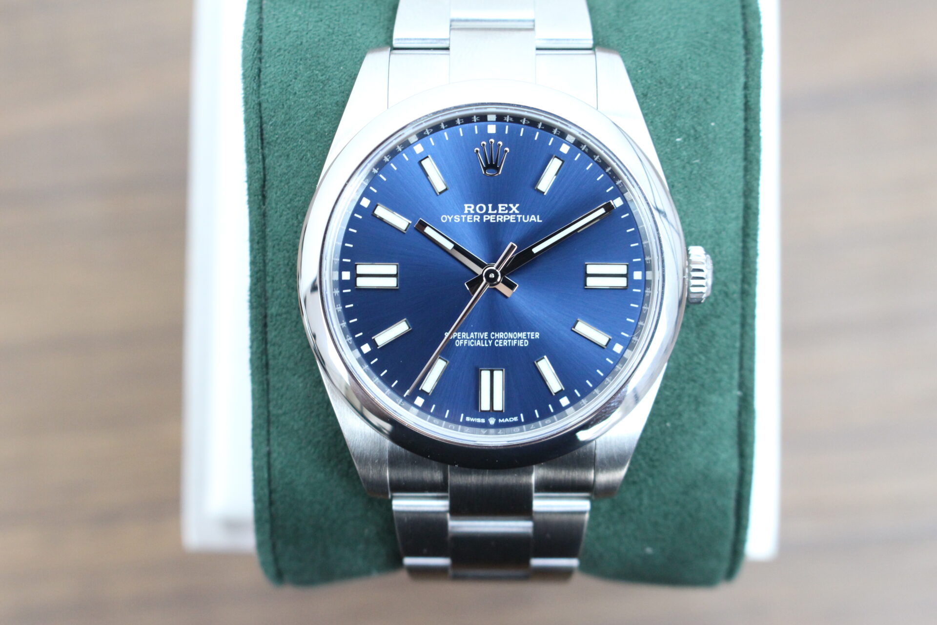 Rolex Oyster Perpetual 41 124300 on a green cushion