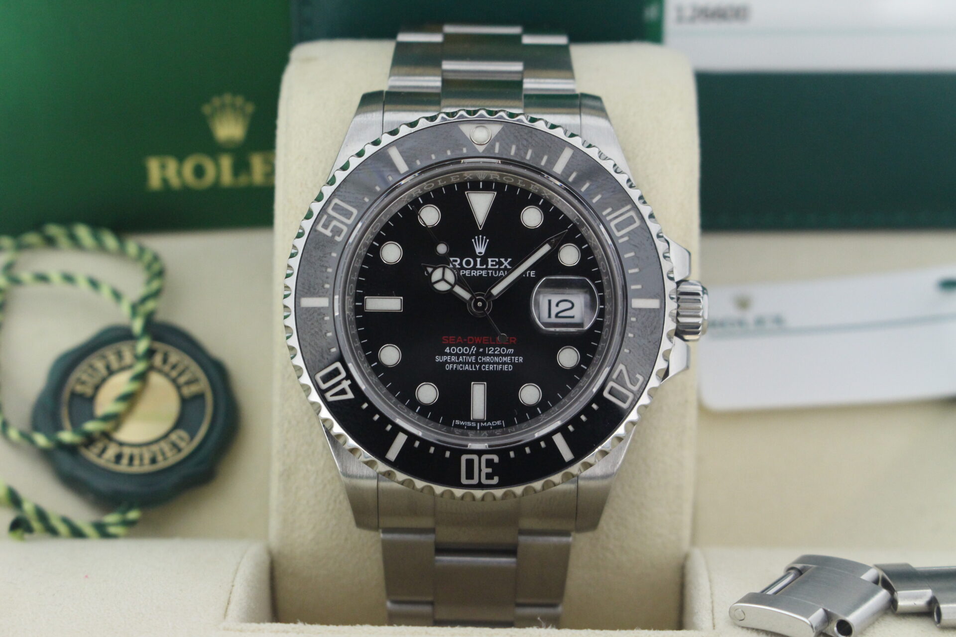 Close up of Rolex Sea-Dweller 50 Anniversary 126600 in it's box with both swing tags, link, booklets and warranty card