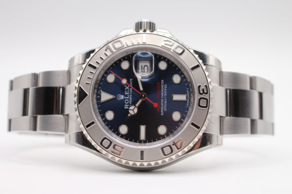 Rolex 116622 fully unworn and stickered laid on its side with a blue dial and red seconds hand