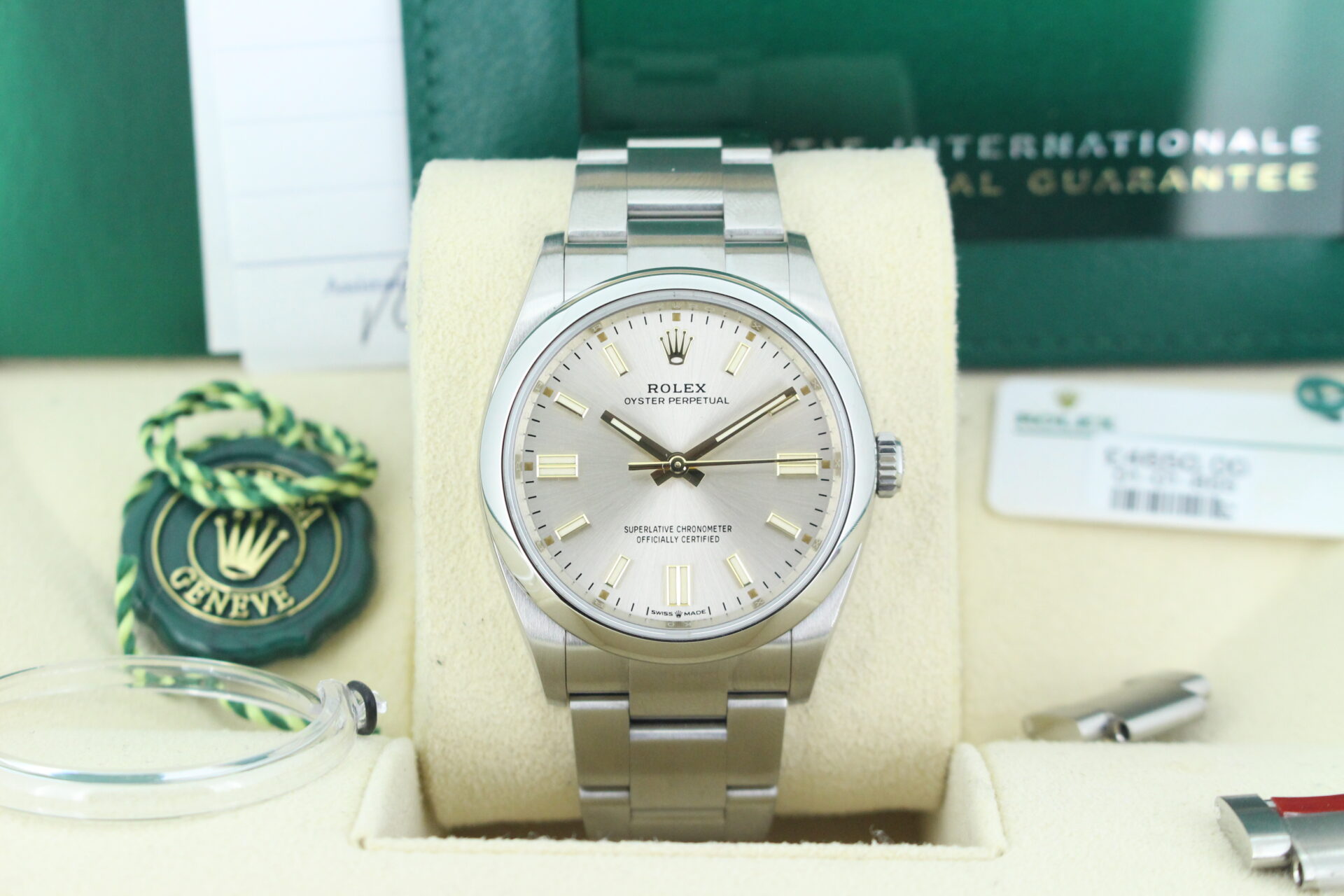 Close up of Rolex Oyster Perpetual 36 Silver 126000 with both swing tags, booklets, original purchase receipt and warranty card