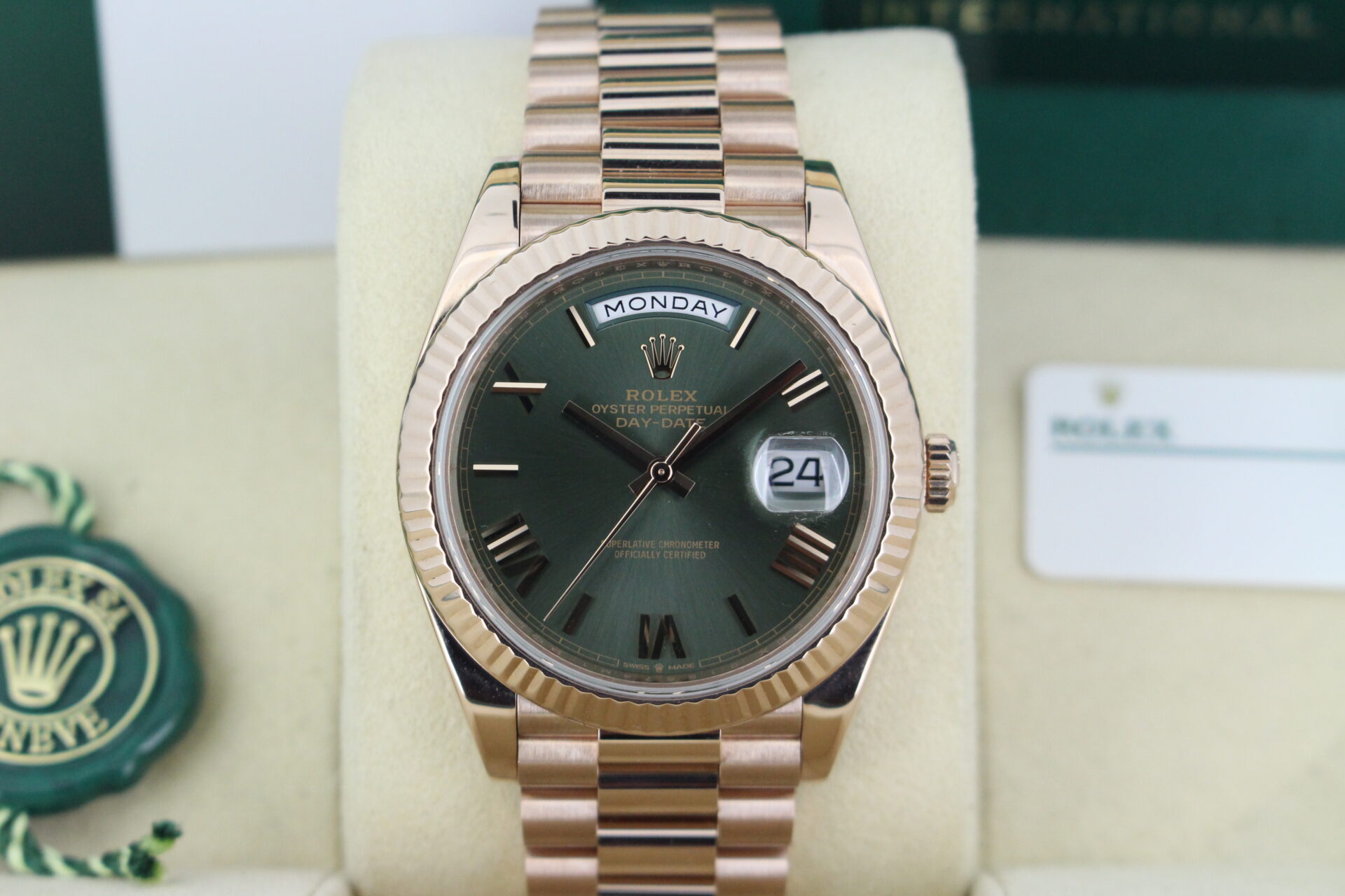 Close up of Rolex Day-Date 40 Rose Gold Olive 228235 in it's box with both swing tags, booklets and warranty card