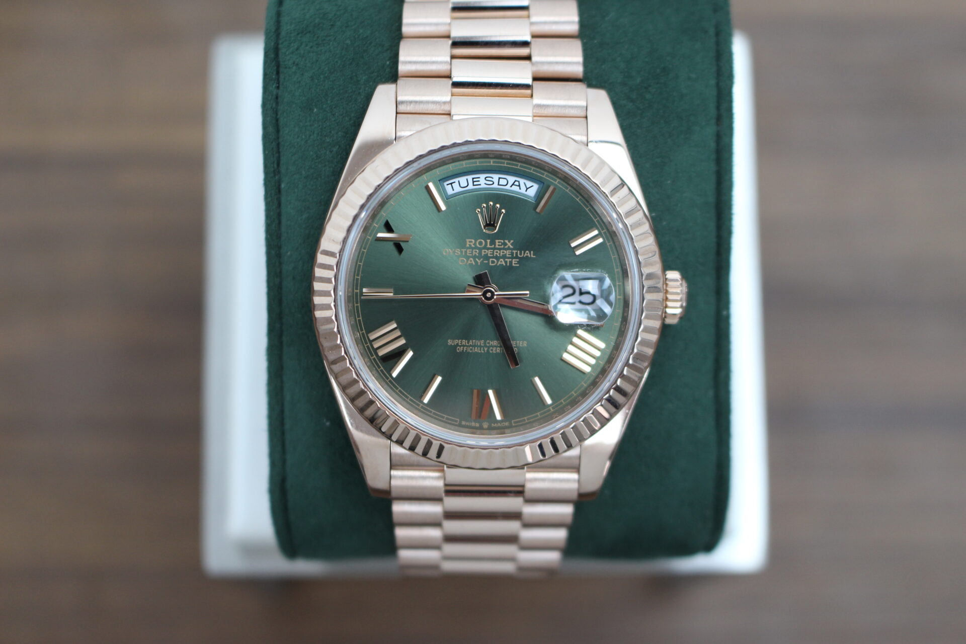 Rolex Day-Date 40 Rose Gold Olive 228235 on a green cushion
