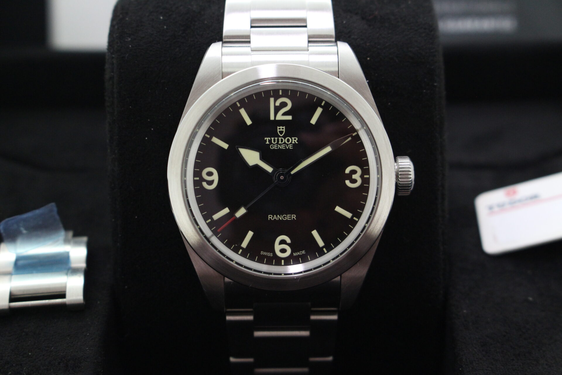 Close up of Tudor Ranger 79950 in it's box with swing tag, link and warranty card