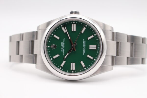 Rolex OP41 green laid down on a white background