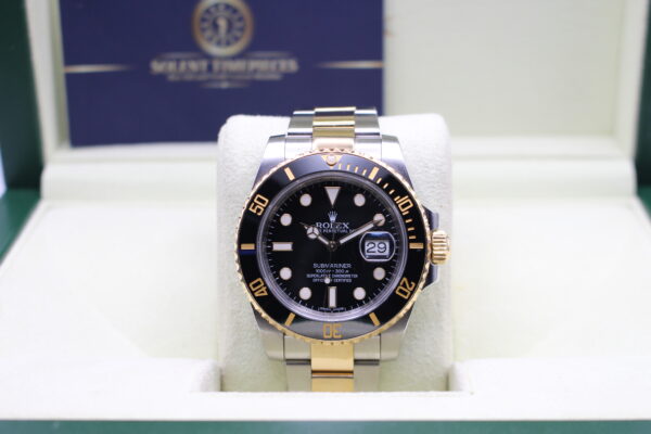 Rolex Submariner two tone with a 18ct gold bezel and oyster bracelet sat in its box