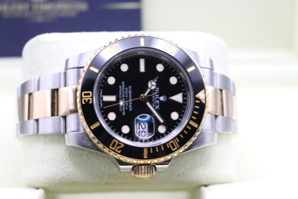 Rolex 116613LN on its watch cushion laid on its side