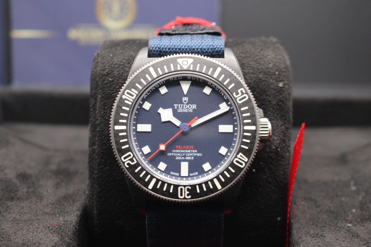 Tudor Pelagos FXD Alinghi Red Bull Racing Edition with its blue dial sat upright on its cushion