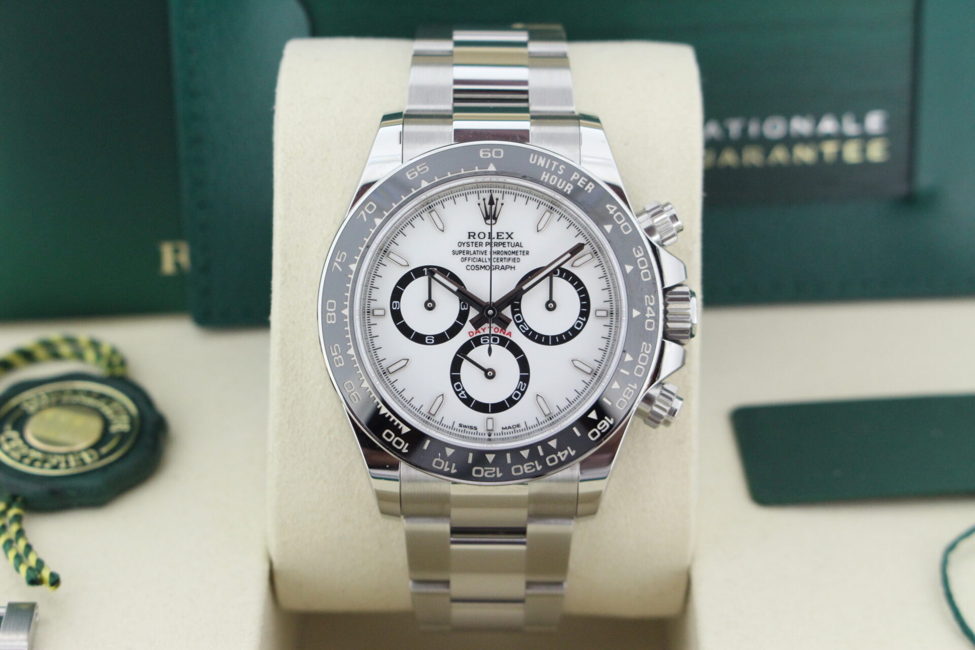 Close up of Rolex Daytona Panda 126500LN in it's box with both swing tags, booklets and warranty card