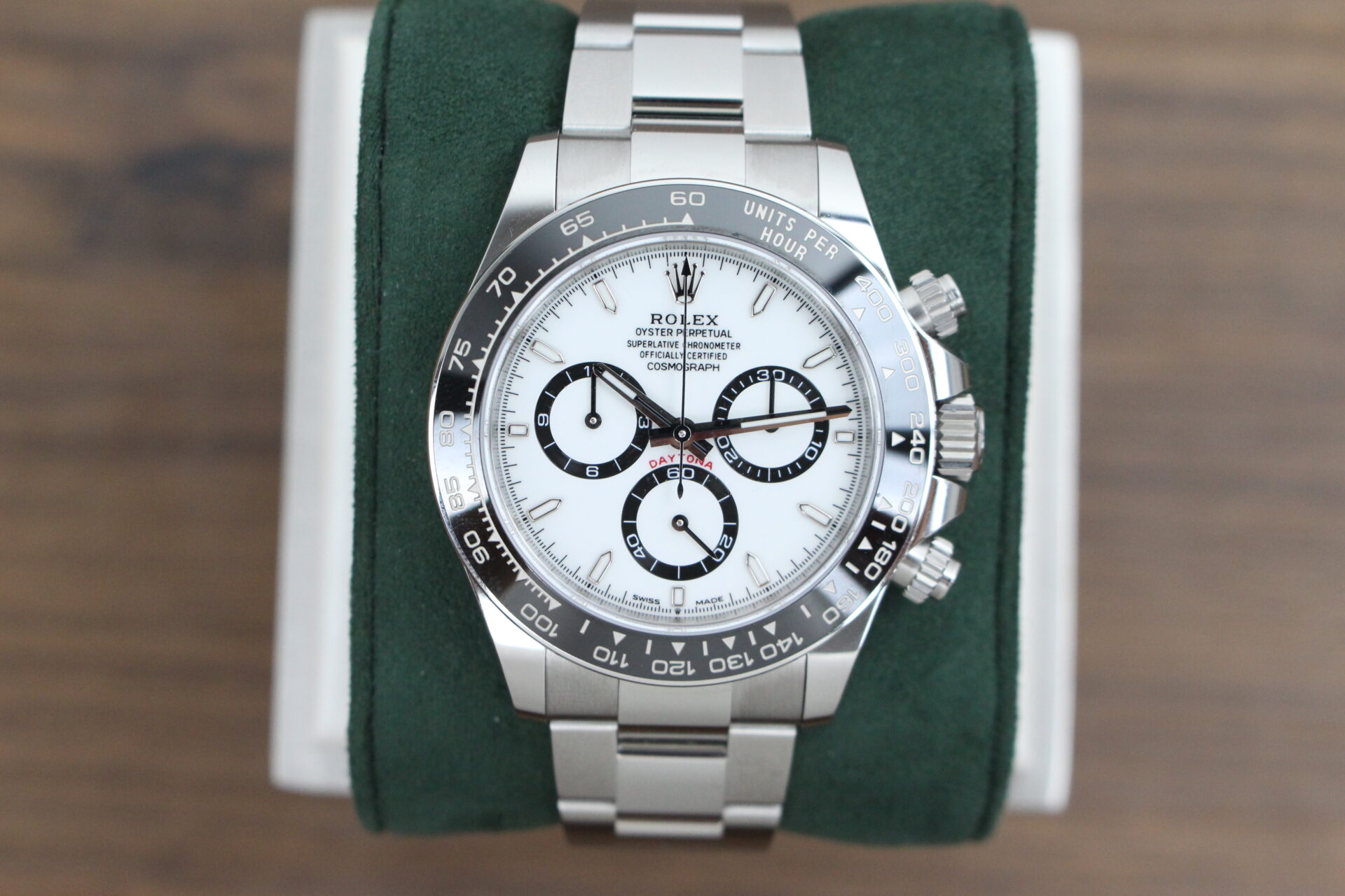Rolex Daytona Panda 126500LN on a green cushion