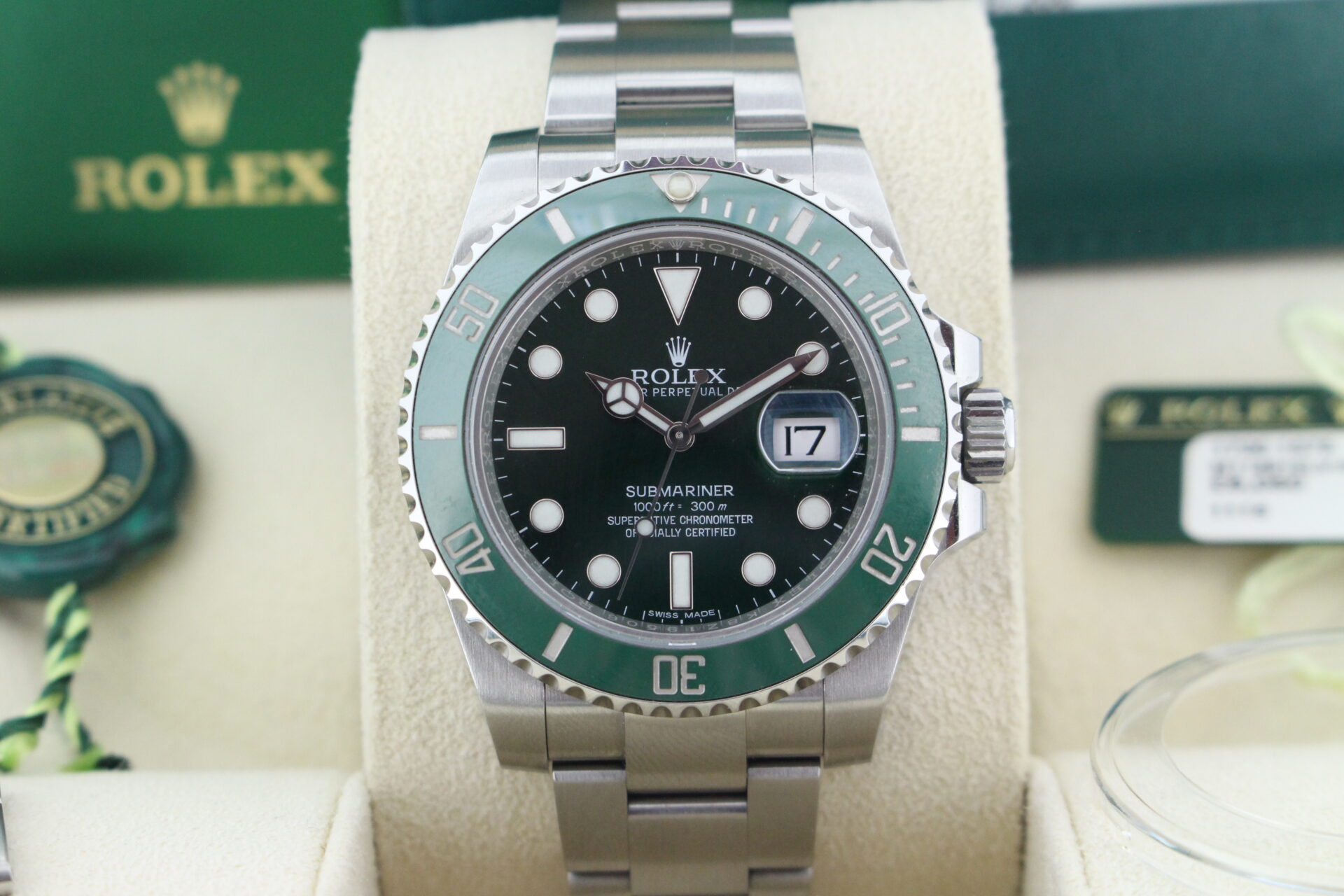 Close up of Rolex Submariner Hulk 40mm 116610LV in it's box with both swing tags, booklets, bezel protector and warranty card