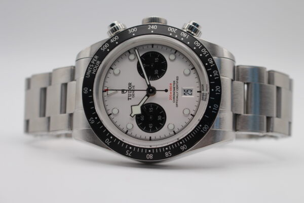 Tudor Black Bay Chrono laid on its side on a white background