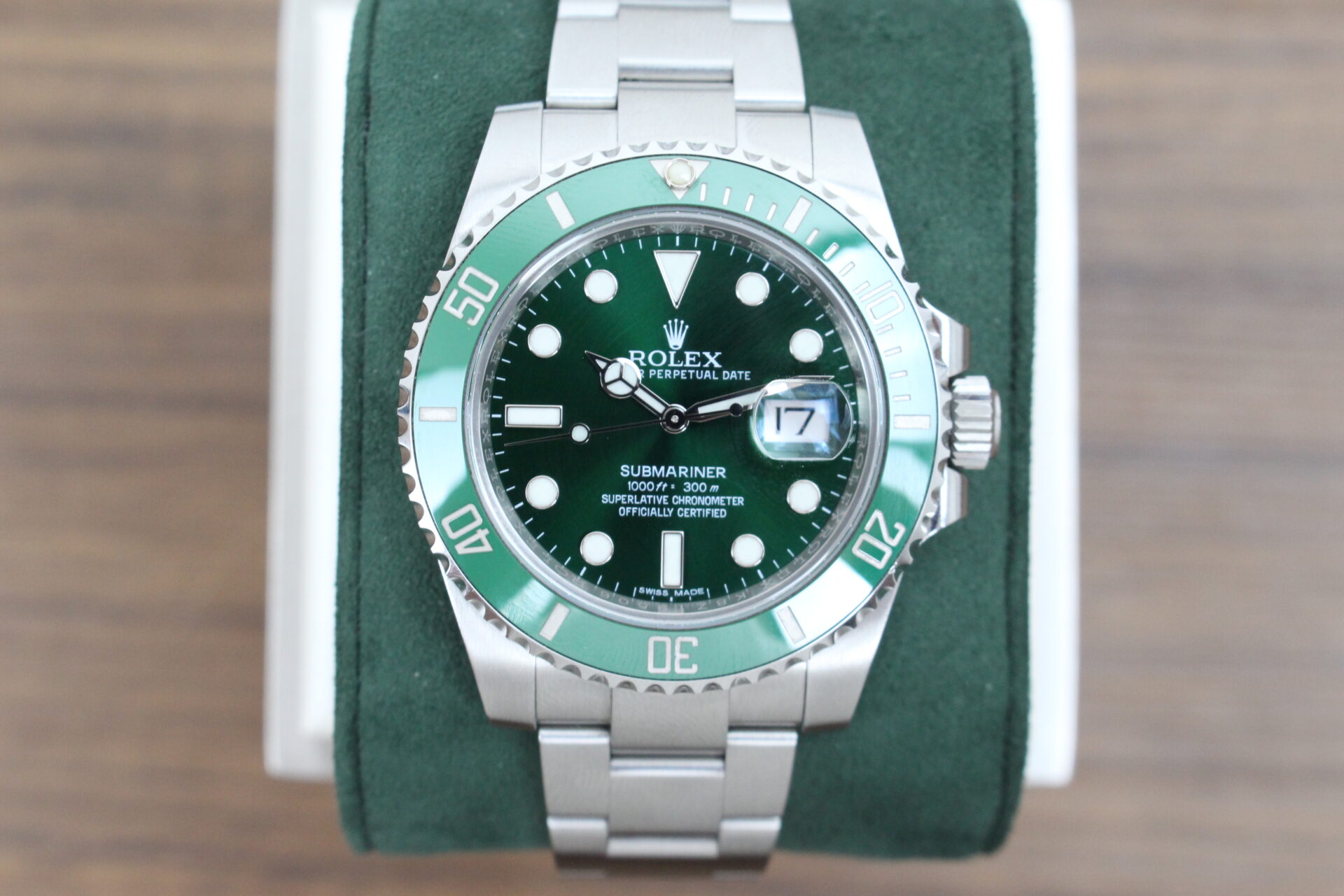 Rolex Submariner Hulk 40mm 116610LV on a green cushion