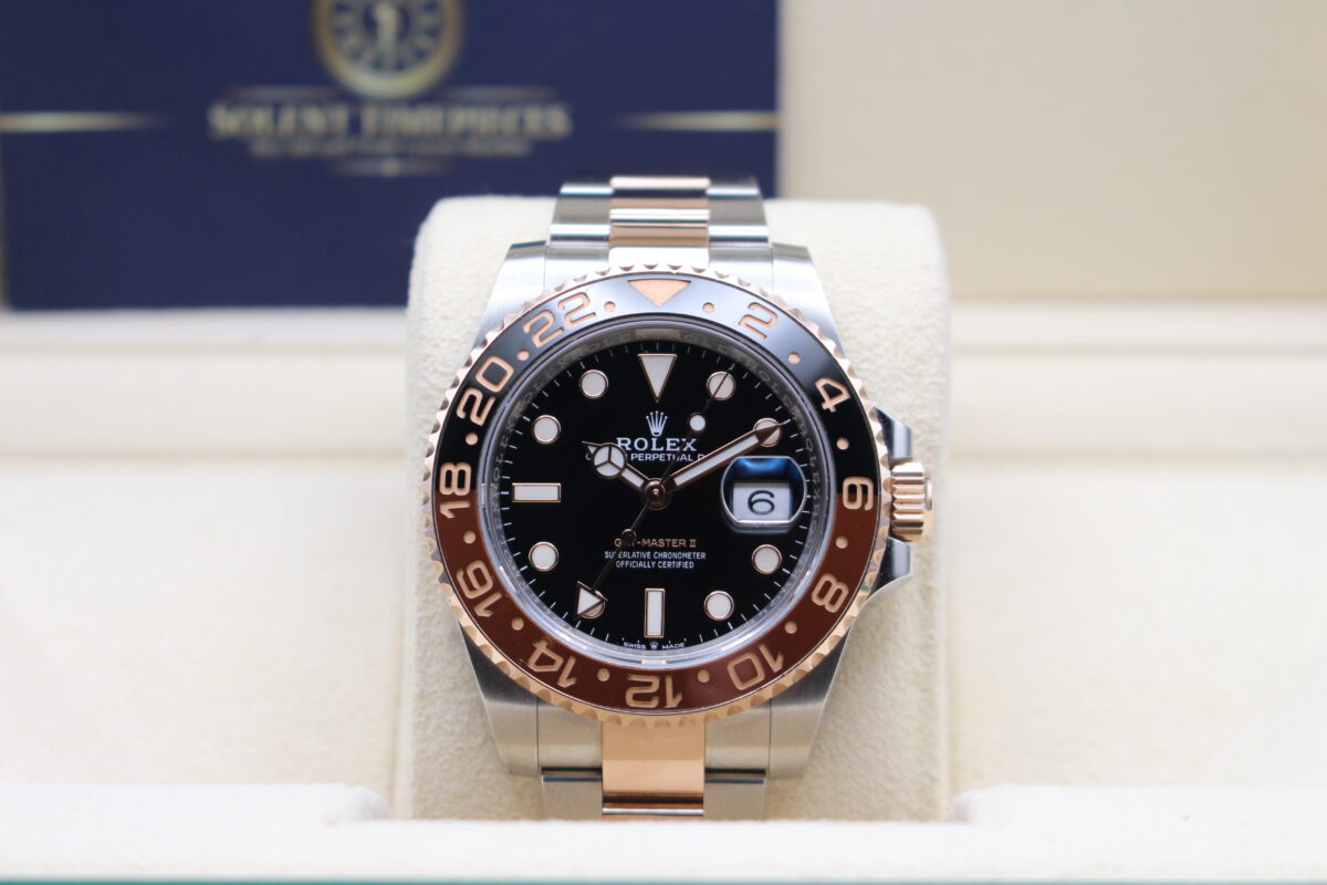 Rolex GMT Master II Rootbeer sat in its box reading 10 past 10