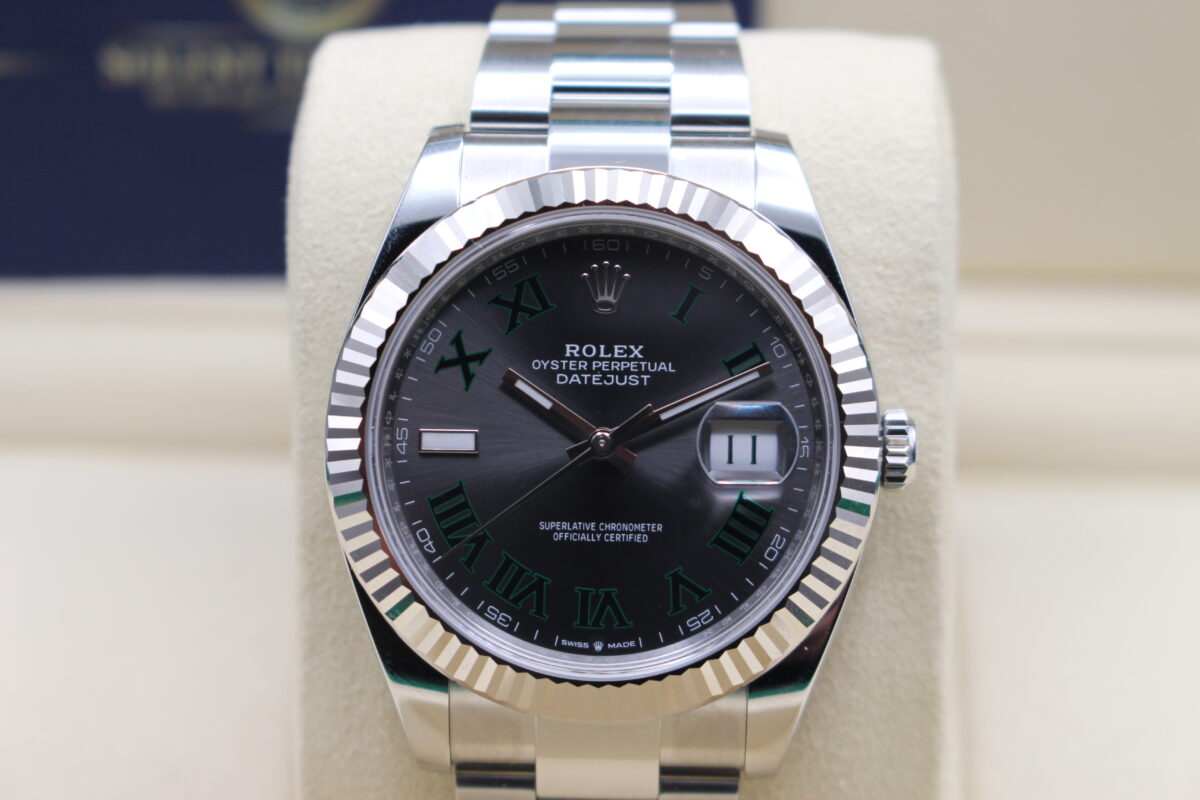 Close up of a Rolex Datejust 41mm fitted with the Wimbledon dial. Sat upright on its cushion