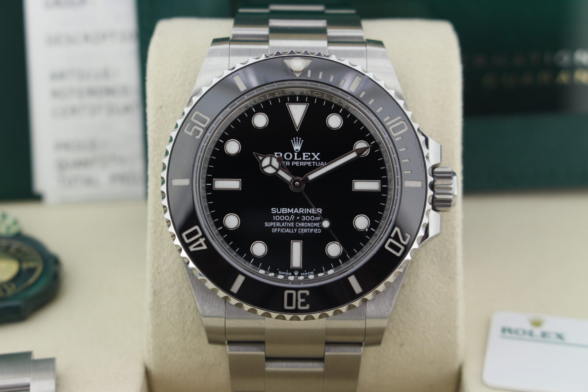 Close up of Rolex Submariner No Date 124060 in it's box with both swing tags, original purchase receipt, booklets and warranty card