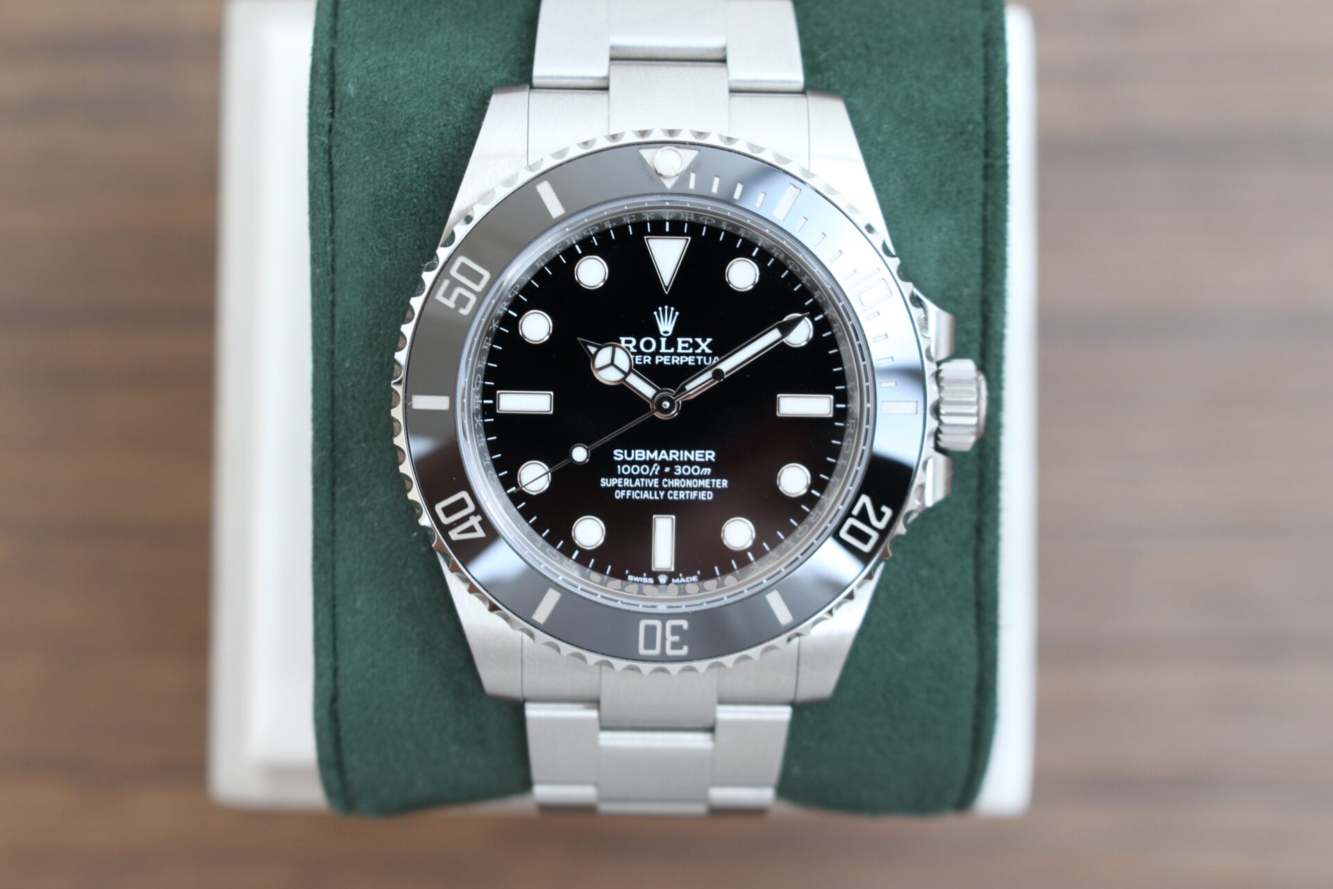 Rolex Submariner No Date 124060 on a green cushion