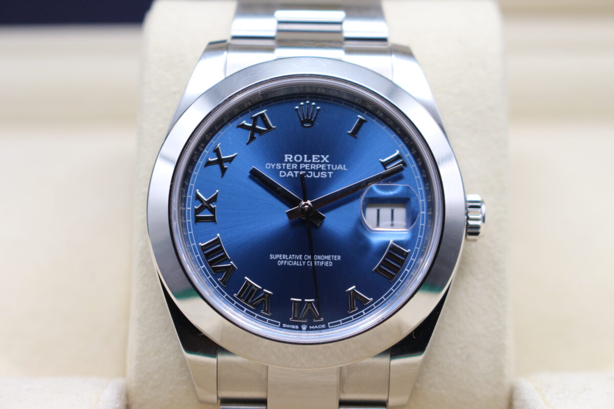 A close up of a rolex Datejust 41mm with a smooth bezel and Azzurro dial