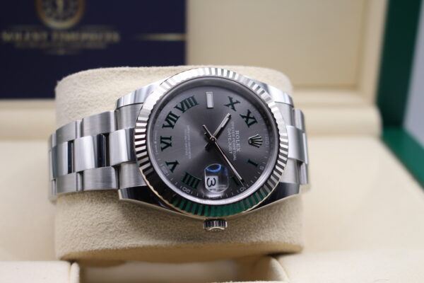 Rolex Datejust fitted with a Wimbledon dial and fluted bezel laid on its side.