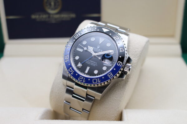 Rolex GMT Master Batman on its cushion inside rolex box leaned back