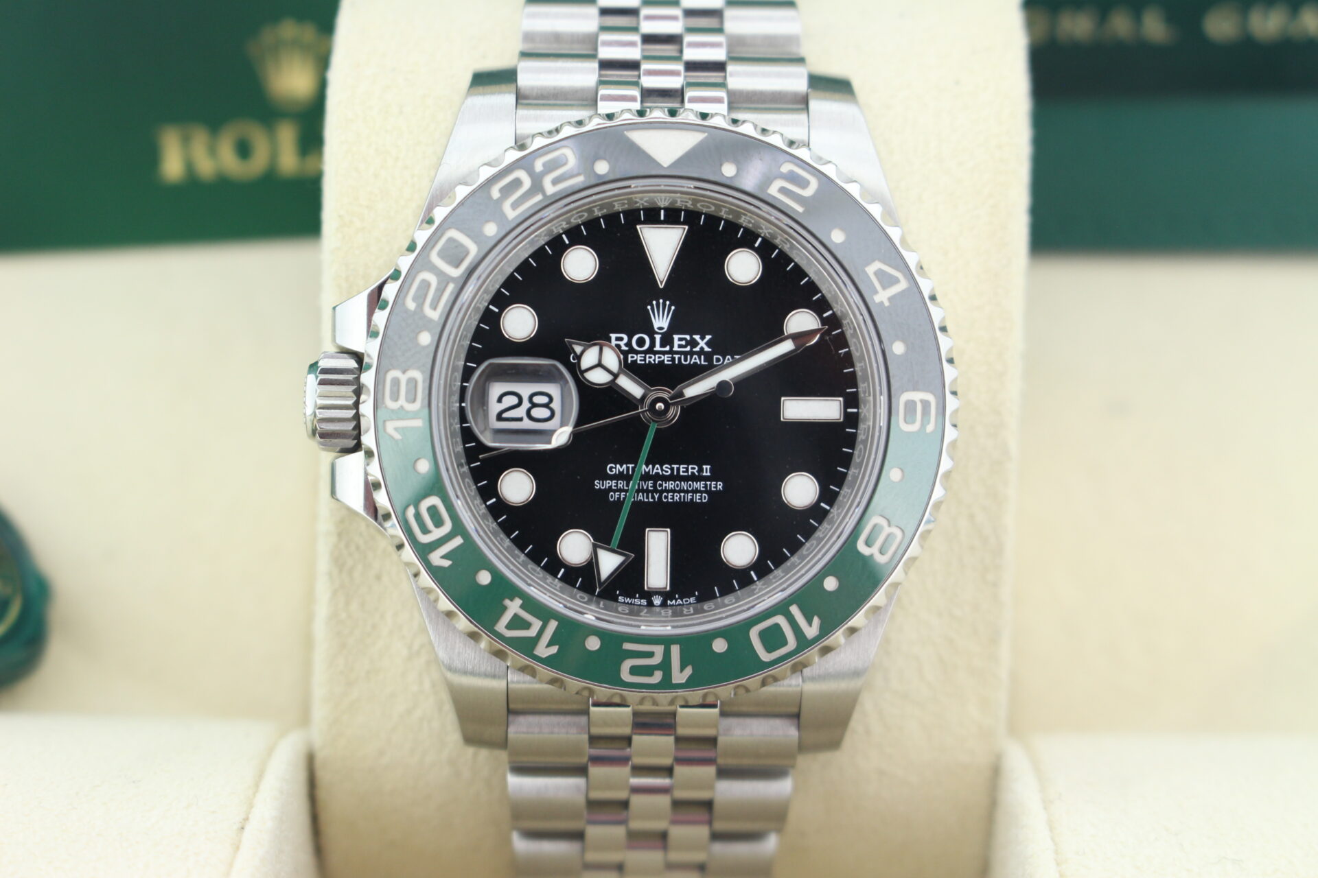 Close up of Rolex GMT Master II Sprite 126720VTNR in it's box with booklets, green swing tags and warranty card