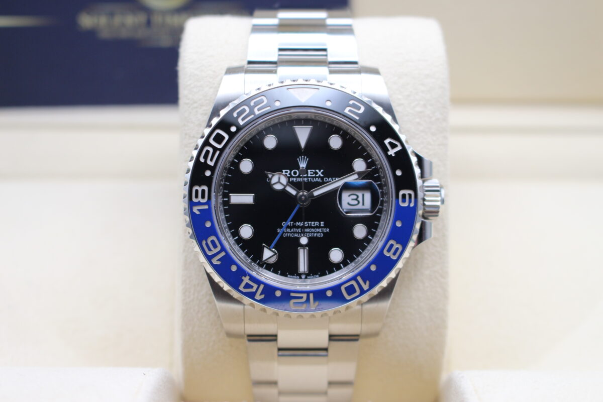 Rolex GMT Master II Batman on its cushion reading 10 past 10