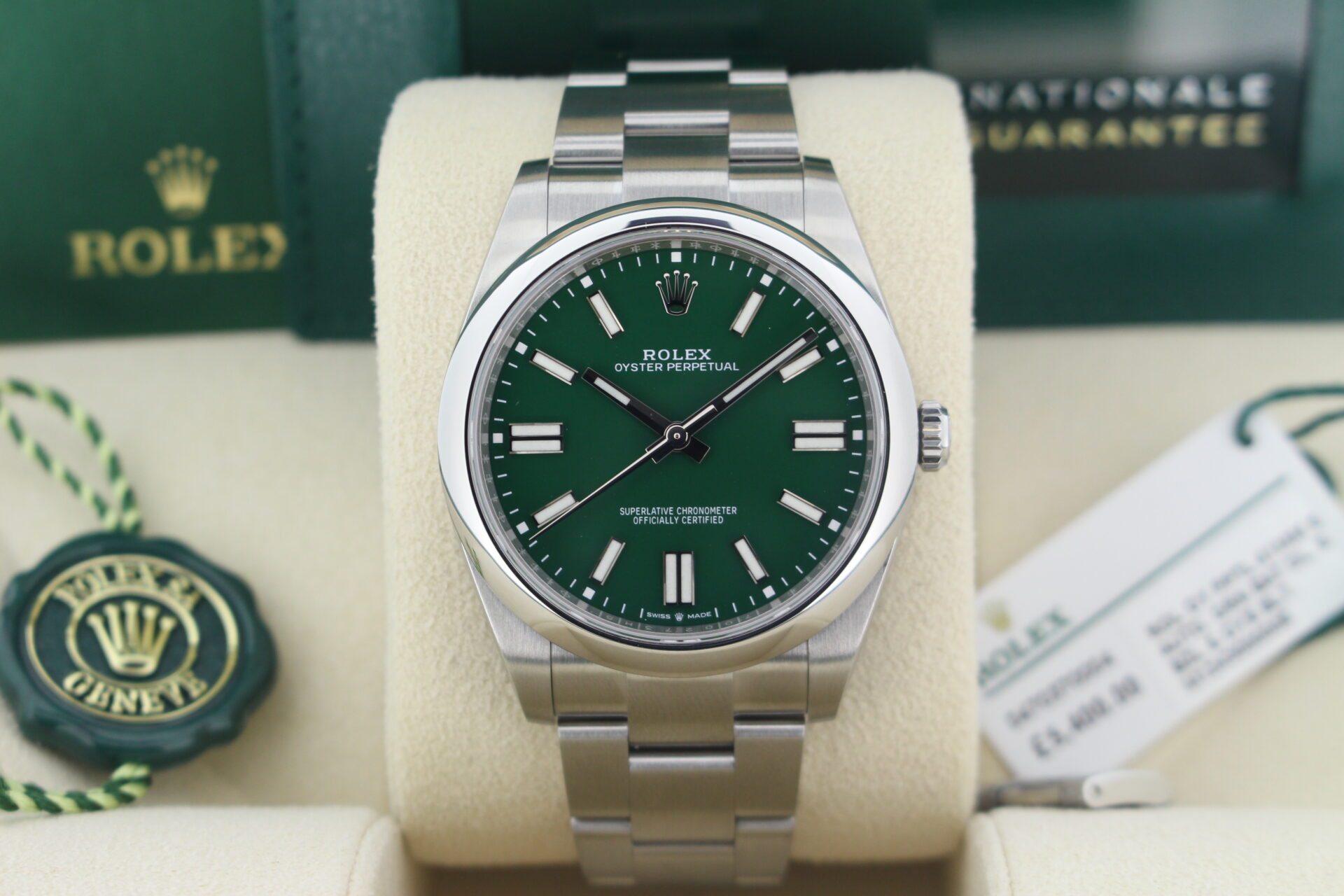 Close up of Rolex Oyster Perpetual 41 Green 124300 in it's box with both swing tags, booklets and warranty card