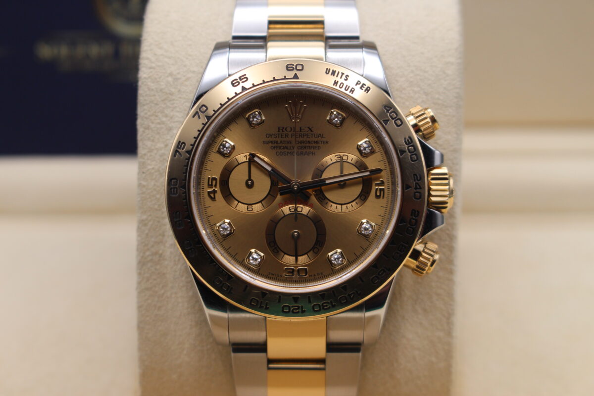 Rolex Daytona 116503. Bi-metal with a champagne diamond dot dial. On a watch cushion with stainless and yellow gold oyster bracelet