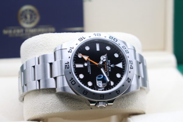 Side view of a black dial Rolex explorer 2 showing off its orange GMT hand