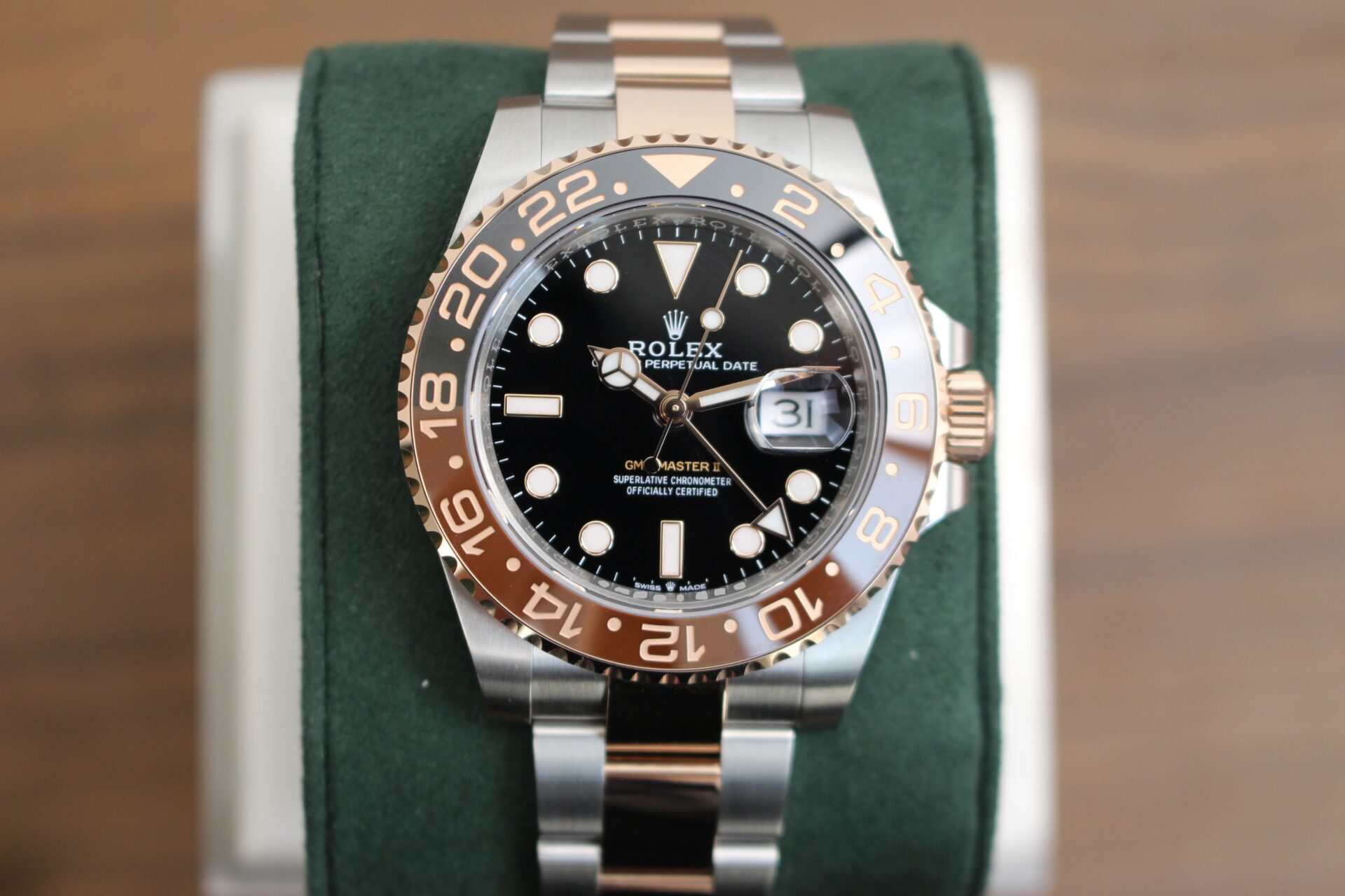 Rolex GMT Master II Rootbeer 126711CHNR on a green cushion