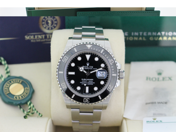Rolex Submariner 126610LN in its box with booklets, swing tags, spare link and Solent Timepieces business card