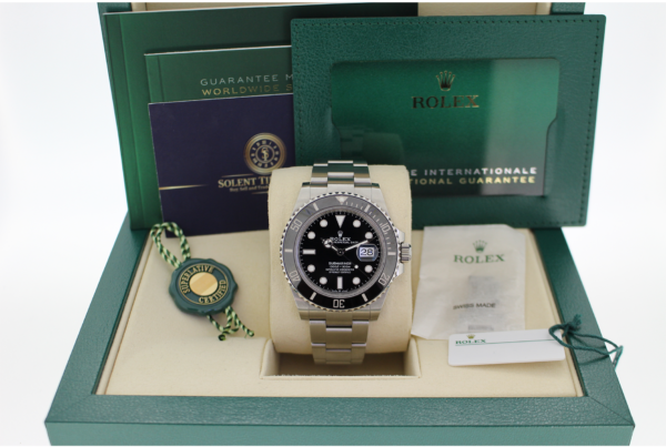 Rolex Submariner 126610LN in its box with booklets, swing tags, spare link and Solent Timepieces business card