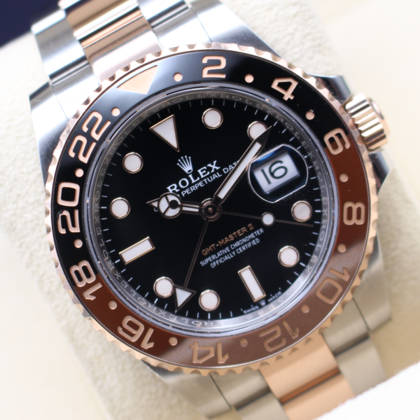 Rolex GMT Master II Rootbeer on display at an angle time reading 10 past 10