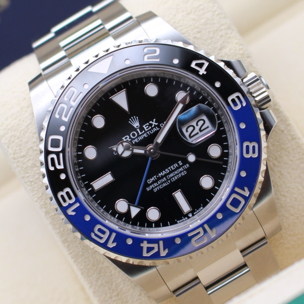 A Rolex GMT Master II Batman Rotated at an angle. Sat on it cushion in a Rolex box