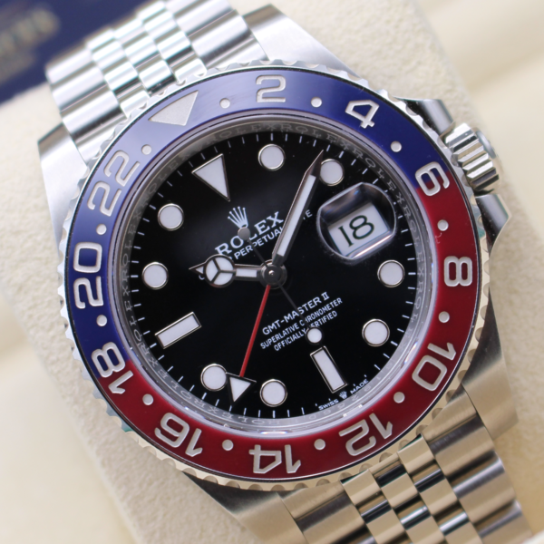 Rolex GMT Master II Pepsi at an angle on its Rolex Cushion